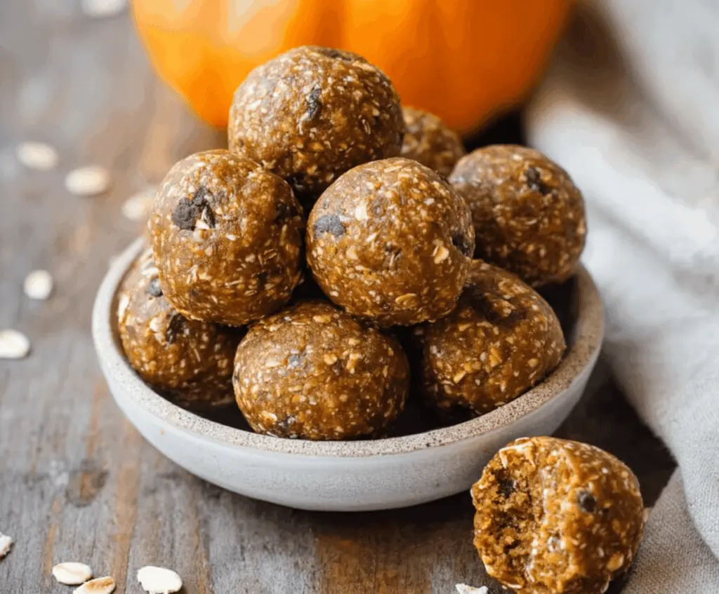 Delicious Paleo Pumpkin Protein Balls on a white plate with pumpkin seeds and cinnamon, perfect healthy snack