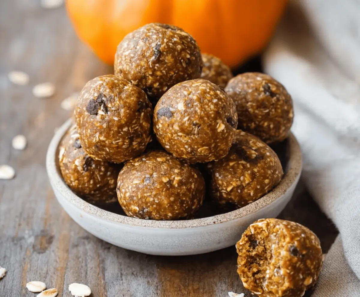 Delicious Paleo Pumpkin Protein Balls on a white plate with pumpkin seeds and cinnamon, perfect healthy snack
