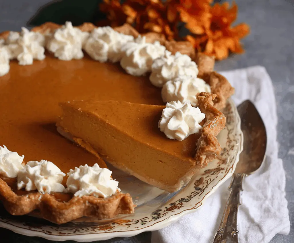 Delicious Pumpkin Butter Pie topped with whipped cream and cinnamon, ready to serve