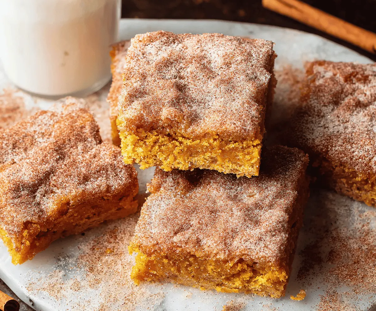 Delicious Pumpkin Snickerdoodle Bars topped with cinnamon sugar, perfect for fall desserts and holiday treats.
