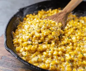Delicious Honey Butter Skillet Corn topped with golden honey and creamy butter in a rustic skillet.