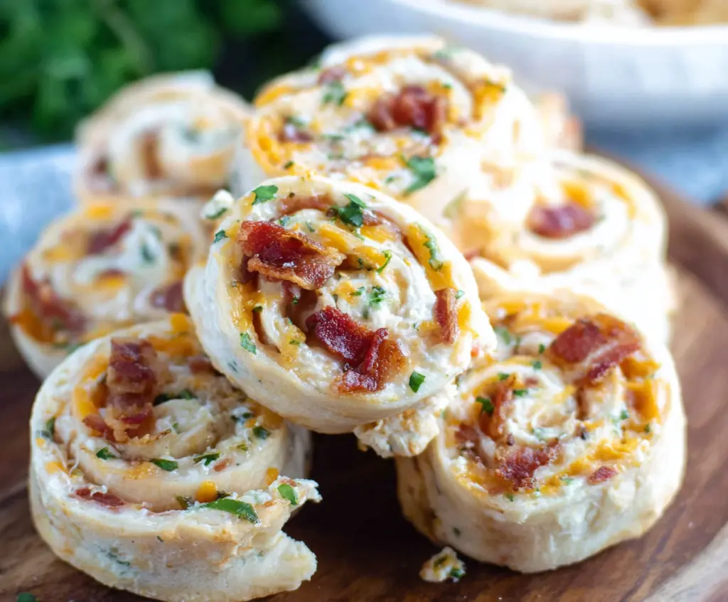 Delicious Bacon Cheddar Ranch Pinwheels served on a platter, perfect for appetizer or party snack.