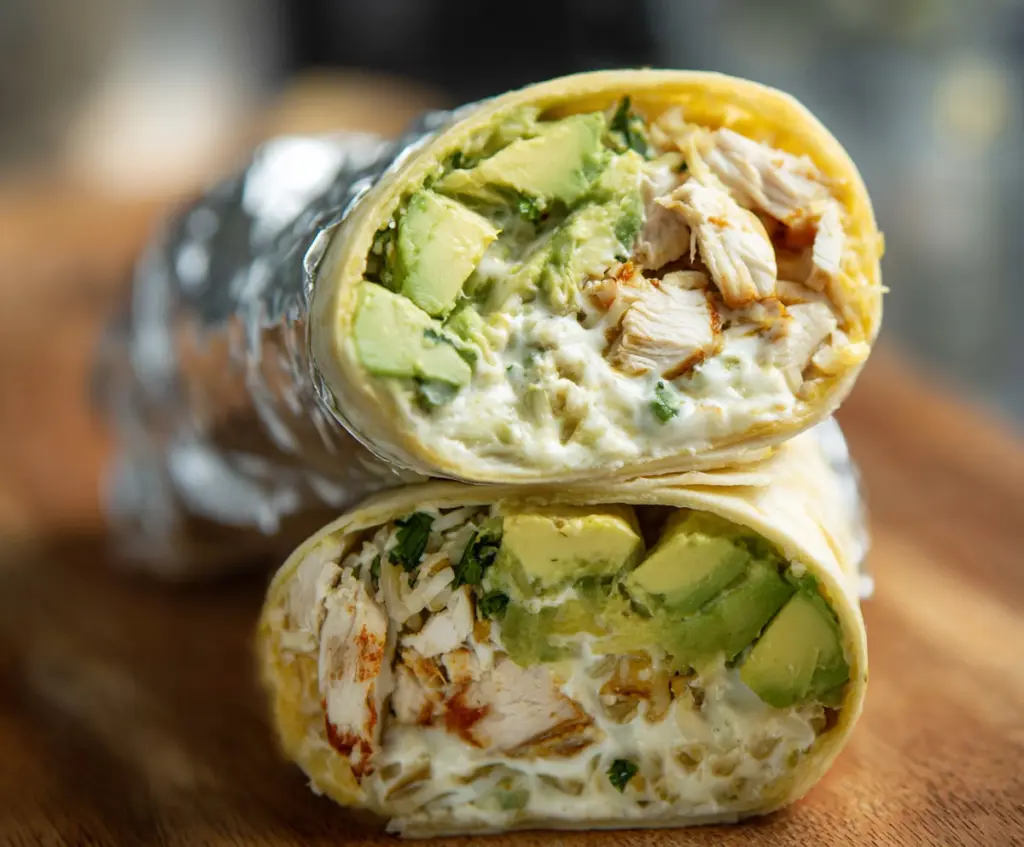 Delicious chicken avocado burrito wrapped in tortilla, featuring fresh ingredients and vibrant flavors.