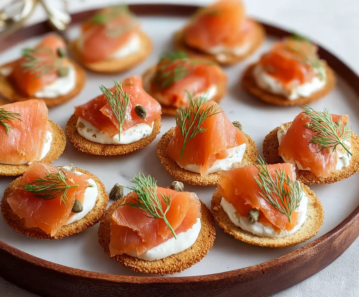 Delicious smoked salmon canapés garnished with herbs served on elegant plates