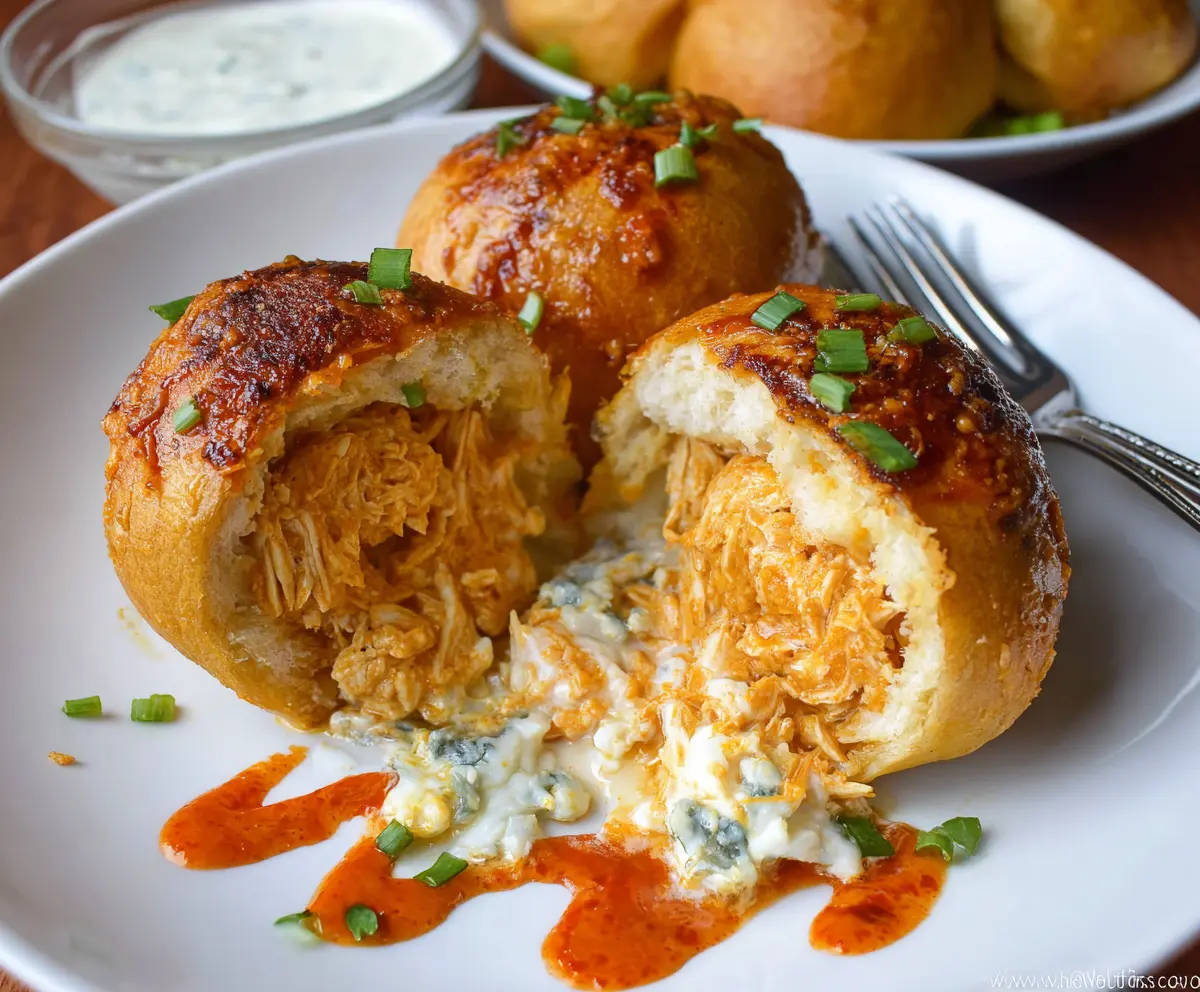 Savory Buffalo Chicken Bombs with melted cheese filling on a plate.