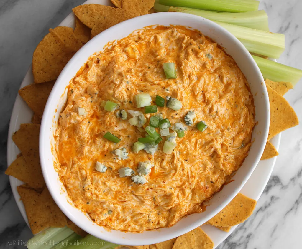 Creamy Greek Yogurt Buffalo Chicken Dip served with celery and crackers.