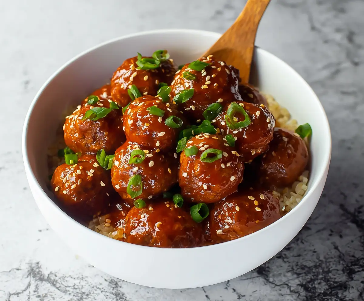 Juicy honey sriracha glazed meatballs served on a platter for a flavorful appetizer.
