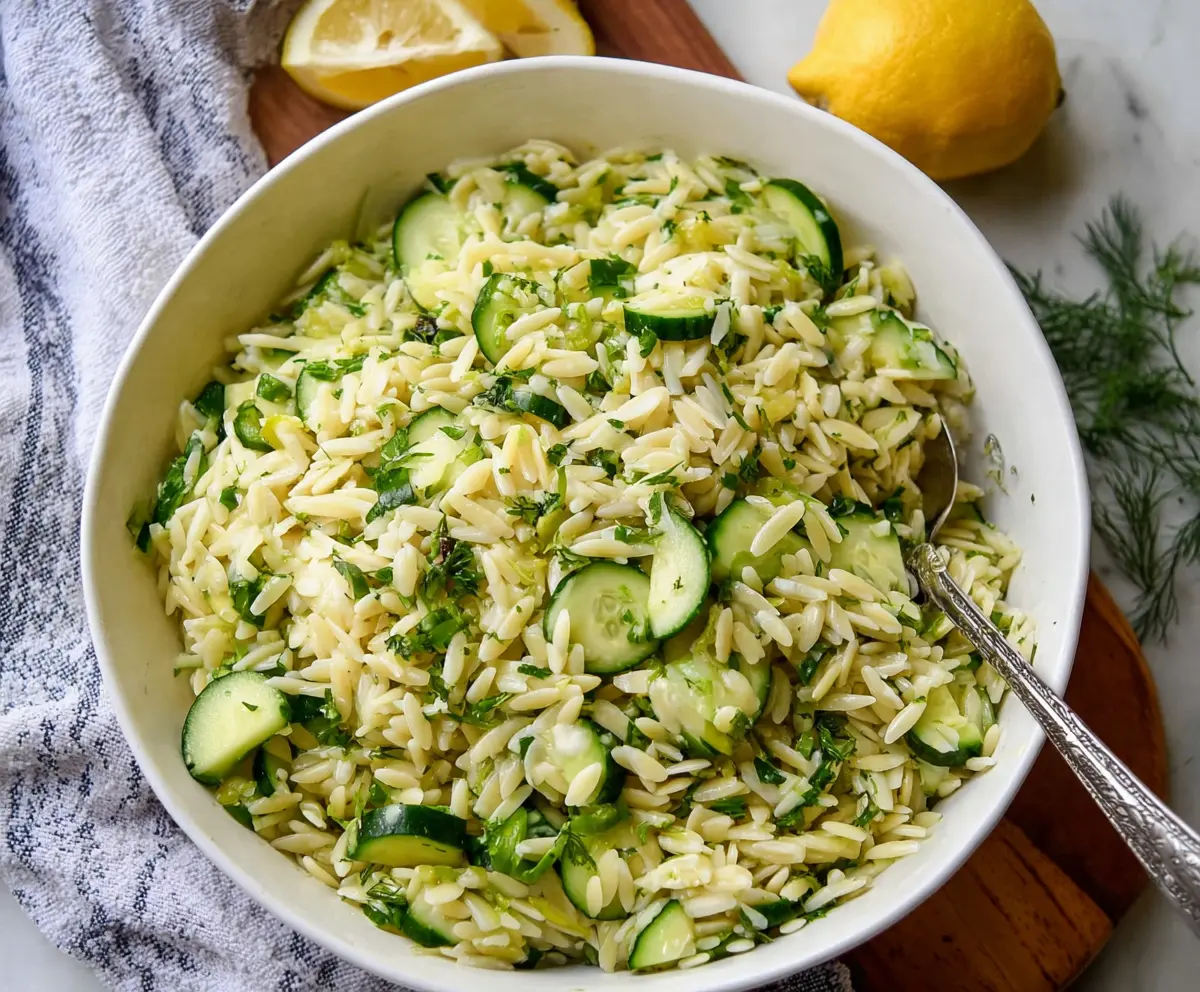 Fresh cucumber and lemon orzo salad in a bowl, perfect for a healthy summer meal