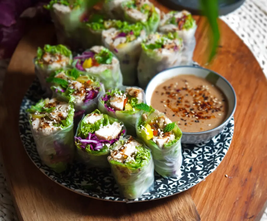 Fresh Caesar Chicken Rice Paper Rolls with crisp vegetables and creamy dressing, perfect for a light lunch.
