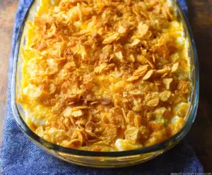 Delicious cheesy potatoes topped with crispy corn flakes, perfect for a comforting meal.