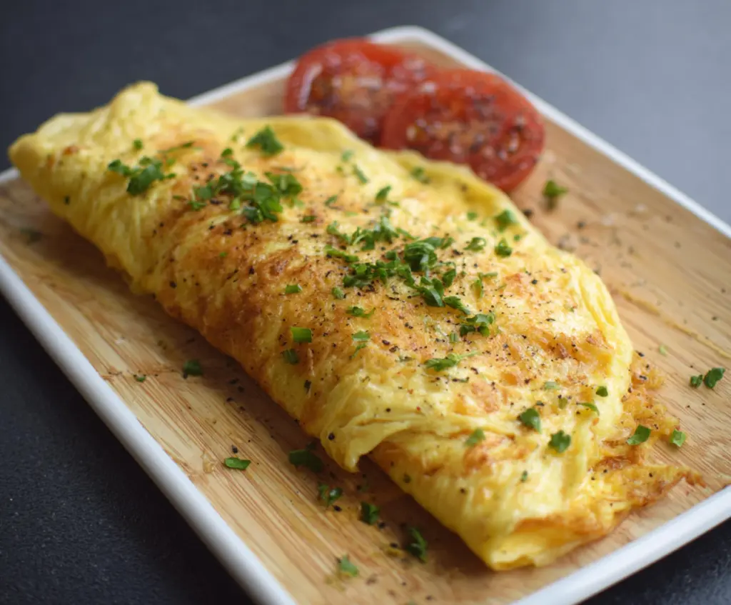 Delicious classic omelet packed with fluffy eggs and melted cheese, perfect for breakfast.