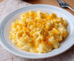 Creamy and cheesy crockpot potatoes with golden melted cheese topping, perfect for comfort food lovers.