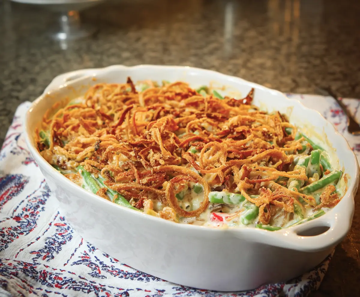 Delicious Green Bean Casserole with crispy fried onions and fresh green beans served in a baking dish
