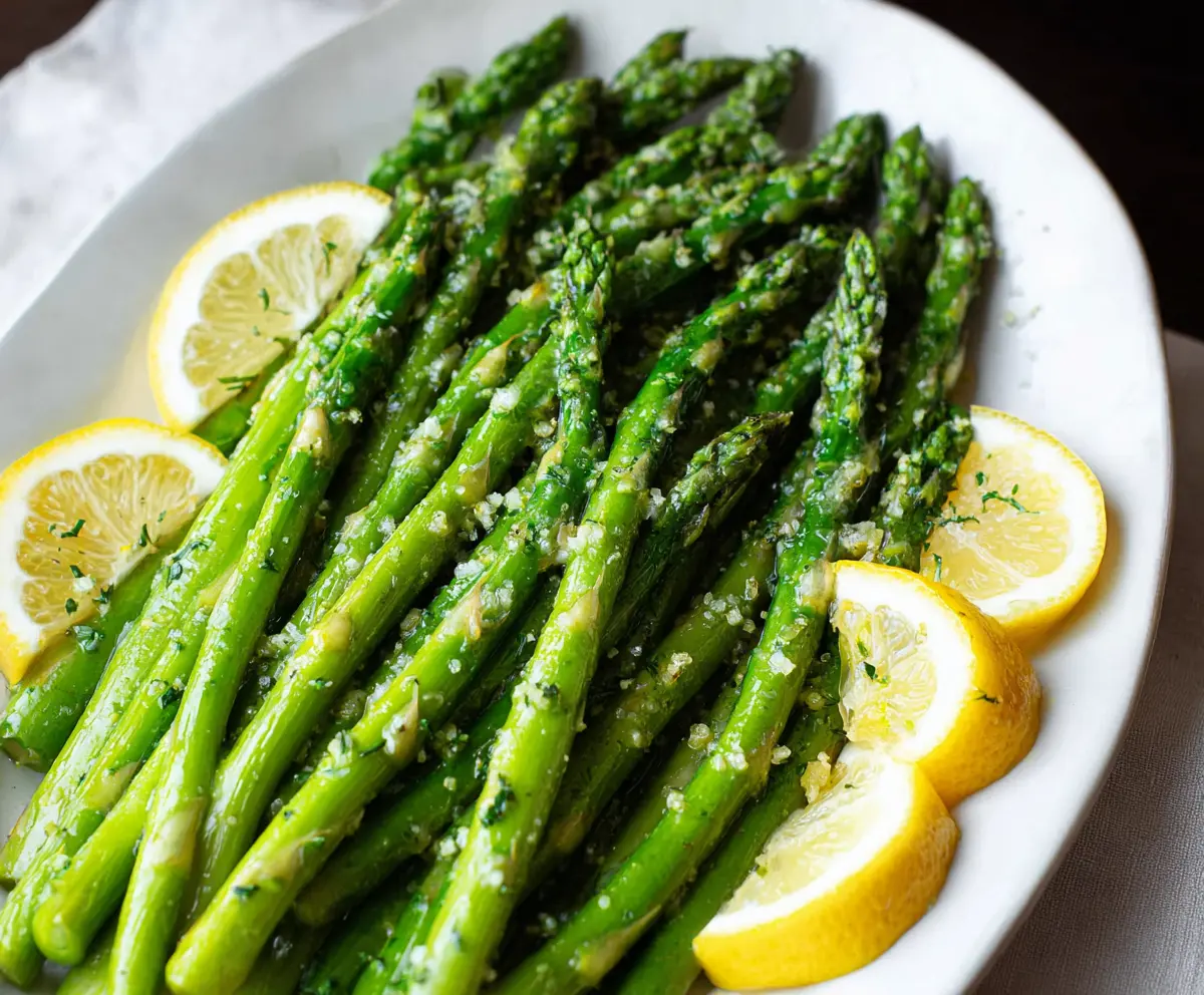 Fresh lemon garlic asparagus dish with vibrant green spears and zesty lemon slices.