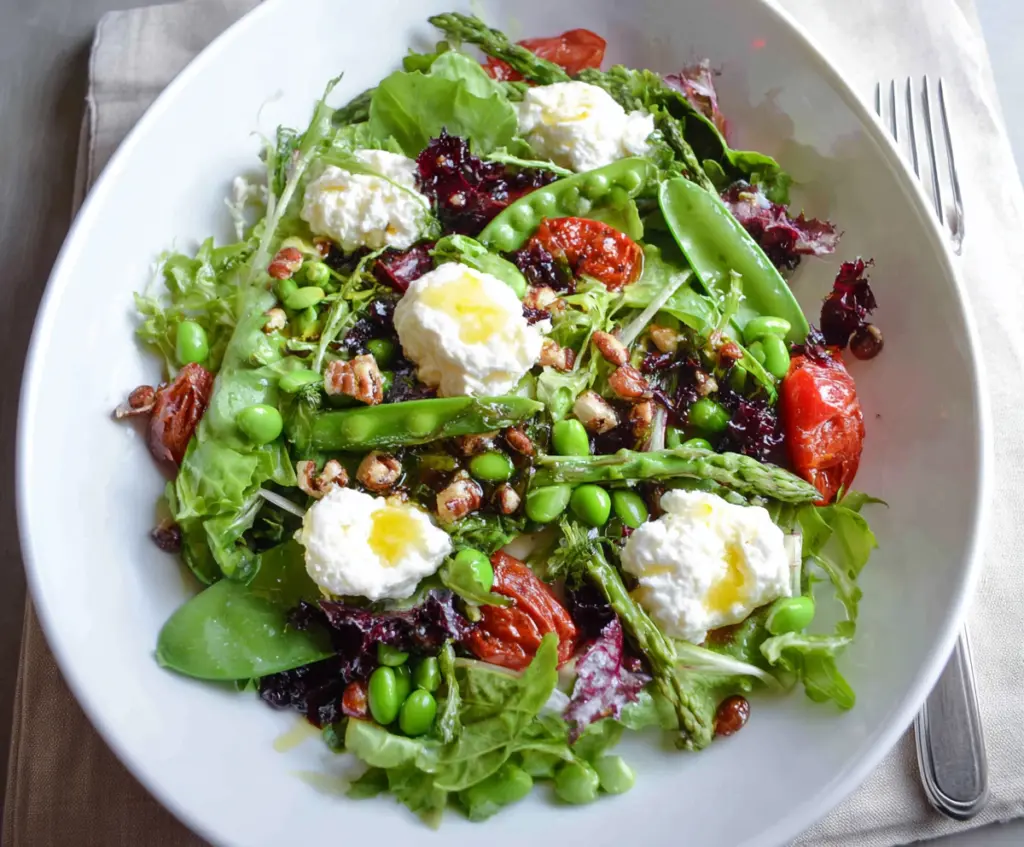 Fresh spring salad with goat cheese, mixed greens, strawberries, and a light vinaigrette.